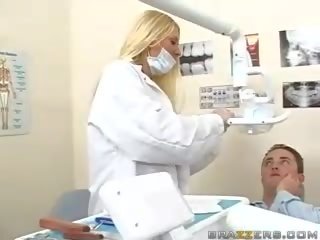 Exceptional teen busty blonde dentist shows her boobs to a patient